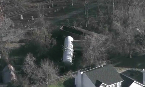Nine rail cars of a 92 car BNSF train derailed in Imperial, MO along a section of track running between cemetary plots on one side and residential homes on the other.