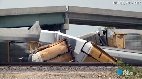 Rail cars and a concrete roadway lay in a heap after a collision between a Union Pacific train and a BNSF train caused a highway overpass to collapse in Rockview, MO on May 25, 2013. The accident injured several motorists.