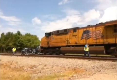 Photo shows wreckage of passenger car down the tracks from the point of impact after a collision with a Union Pacific train at a rail crossing in Troup, TX on May 10, 2013.