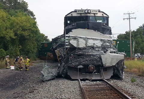 Debris from a shattered concrete beam covers the front of a Norfolk Southern locomotive that collided with a tractor-trailer in Monroe Township, PA on September 12, 2013. Photo credit: Jason Malmont/The Sentinel