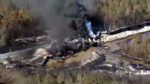A train carrying tankers of crude oil derailed while crossing a wooden trestle in a western Alabama wetlands causing an explosion and fire on November 8, 2013.